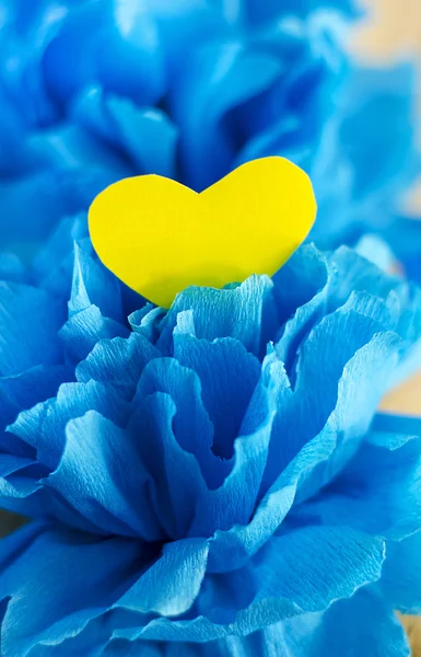 Yellow heart in a blue flower Stock Photo