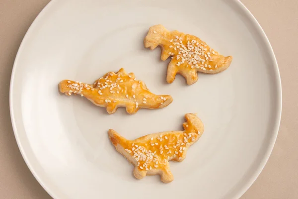 Dinosaur shaped salty cookies — Stock Photo, Image