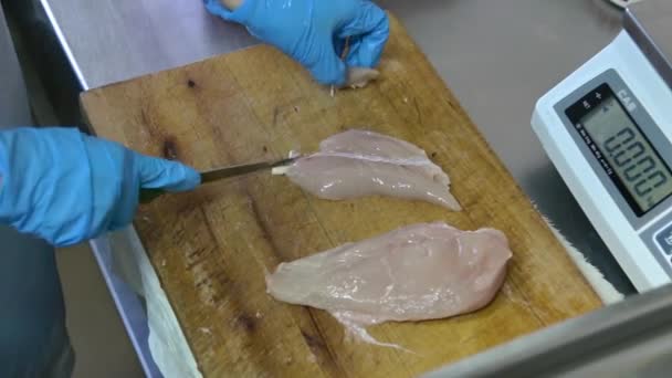 Cook corta o peito de frango cru em porções e pesa-os antes de cozinhar — Vídeo de Stock