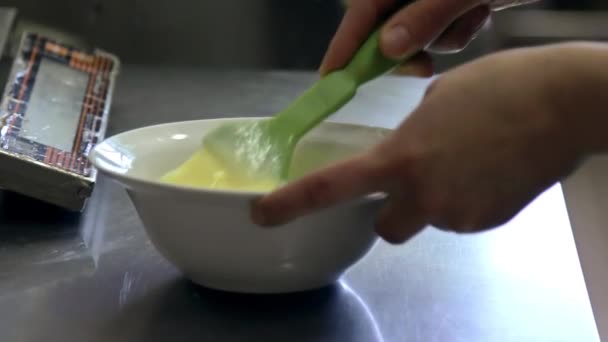 Chef whips eggs by corolla in soup plate — Stock Video