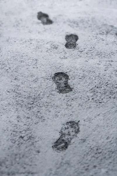 Man footprint on the frozen concrete.