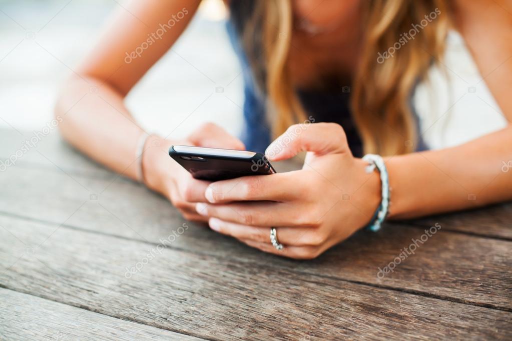 young  girl  holding a smart phone