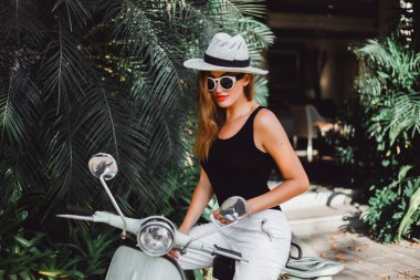 young girl on  vintage scooter