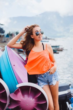 young girl standing on a pier