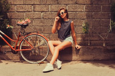 girl  posing with red bicycle