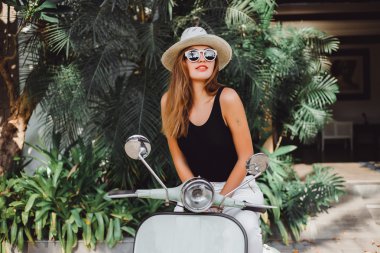 young girl on  vintage scooter