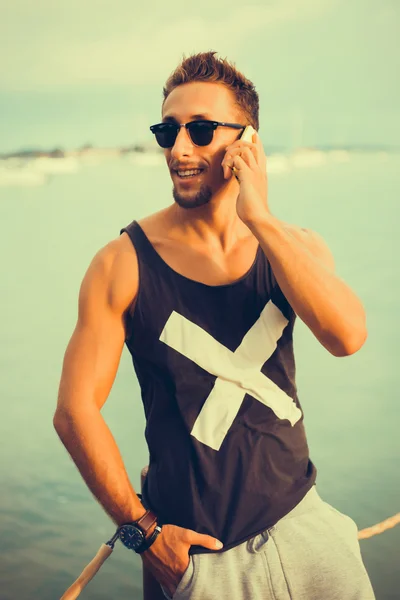 Young guy  talking on the smartphone — Stock Photo, Image