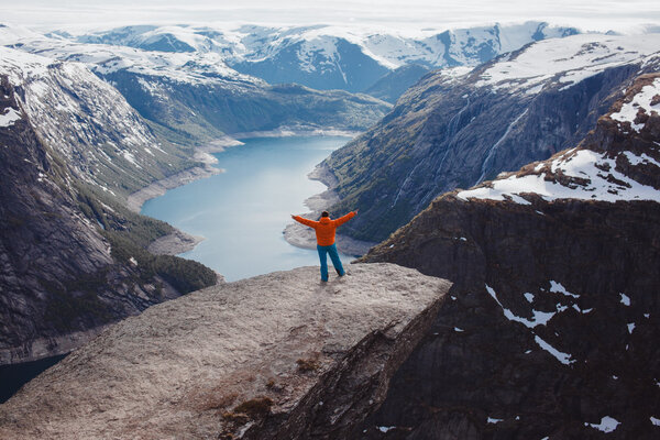 man posing at troll tongue,at Norway
