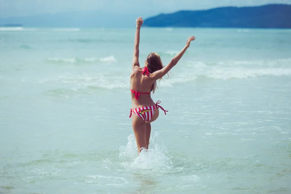 Mädchen im Badeanzug posiert am Strand — Stockfoto