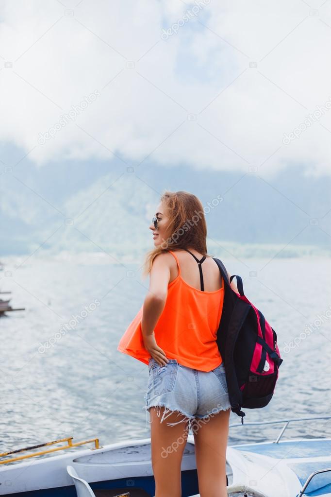 young girl standing on a pier