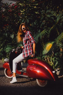 beautiful girl on Vespa scooter