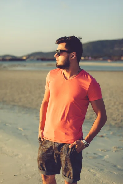 Young man in sunglasses at sunset — Stock Photo, Image