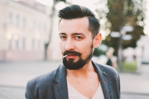 Guy with a beard  smoking a cigarette — Stock Photo, Image