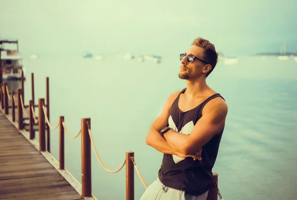 Stylish young guy  on the pier — Stock Photo, Image