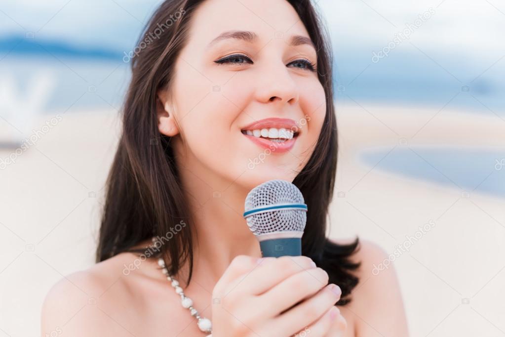 girl singing into  microphone