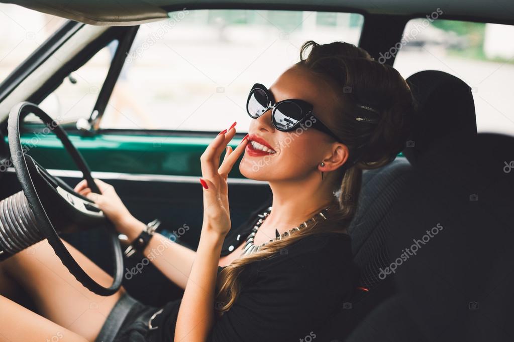 beautiful girl  sitting in a vintage car