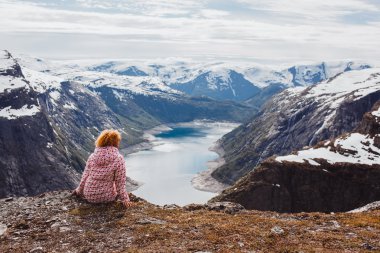 girl   on a rock , Norway fjords clipart