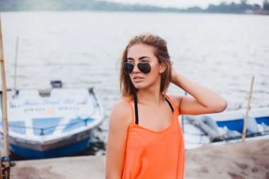 young girl standing on a pier