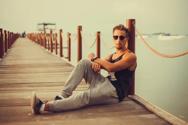 Stylish young guy  on the pier — Stock Photo, Image