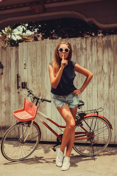 Дівчина позує з вінтажним велосипедом — стокове фото
