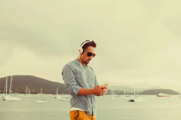 Tipo escuchando música en auriculares — Foto de Stock