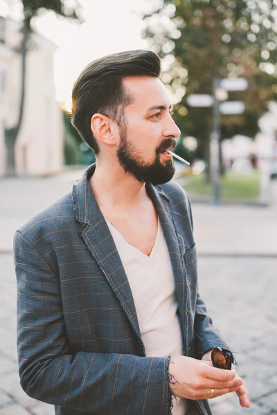 Killen med skägg röka en cigarett — Stockfoto