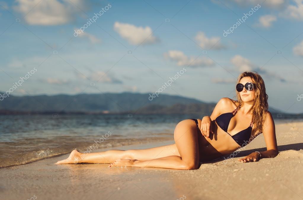 Portrait of a beautiful young woman posing on the beach shore in Vietnam.  stock photo - OFFSET