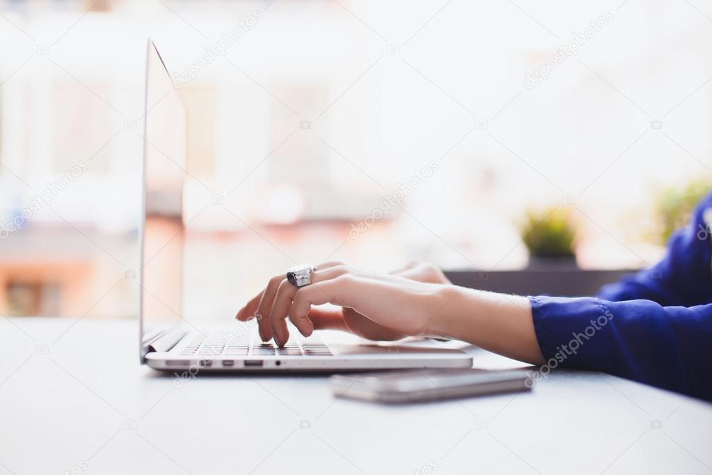 girl works at cafe on  laptop