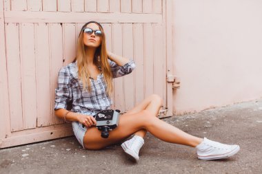 hipster woman with video camera