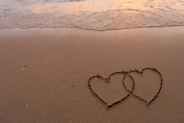 Two hearts drawn in beach Stock Picture