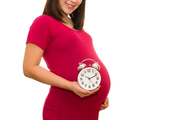 Mujer embarazada sosteniendo reloj de pared. Es la hora. Aislado sobre blanco . — Foto de Stock