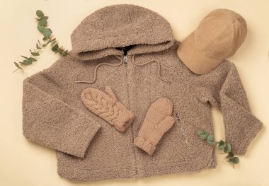 Bej arka planda kadınların modaya uygun bahar kıyafetleriyle yatıyordu.