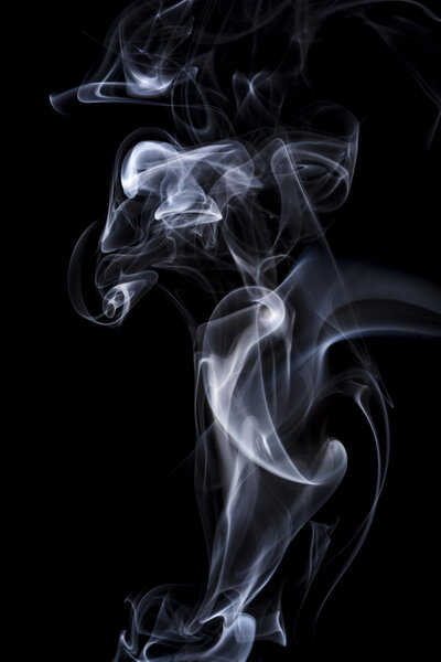 Steam rising in front of a black background.
