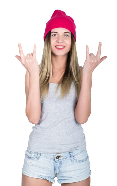 Teenager girl in denim shorts and a gray T-shirt and a pink knit hat, tied at the hips plaid shirt. showing thumbs up sign heavy metal. isolated on white background — Stock Photo, Image