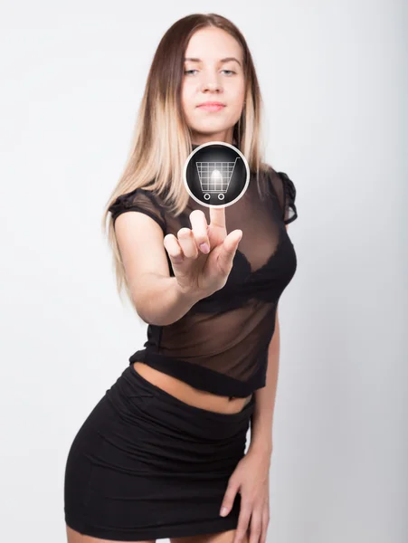 Technology, internet and networking concept. beautiful woman in a short black skirt and a transparent top. woman presses shopping button on virtual screens — Stockfoto
