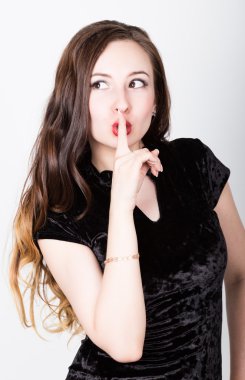 young womans portrait with different happy emotions. Girl brought a finger to his lips, a gesture of silence