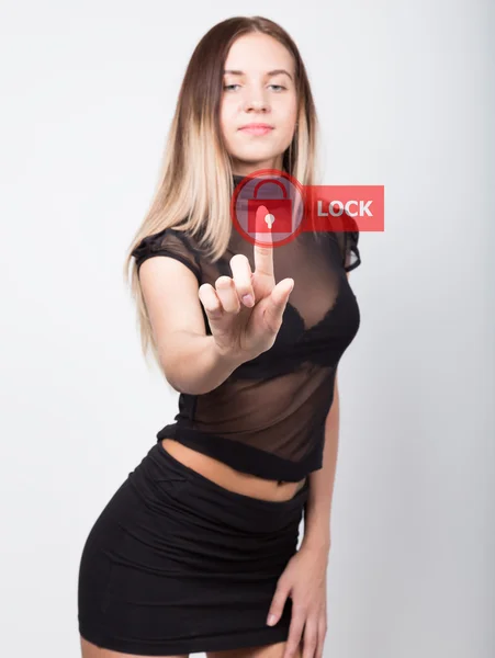 Technology, internet and networking concept. beautiful woman in a short black skirt and a transparent top. woman presses lock button on virtual screens. — Stock Photo, Image