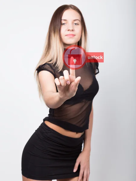 Technology, internet and networking concept. beautiful woman in a short black skirt and a transparent top. woman presses unlock button on virtual screens. — Stock Photo, Image