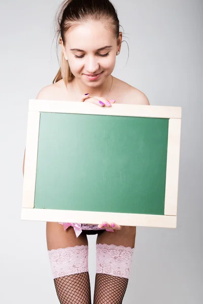 Dantel iç çamaşırı çıplak kız bir tebeşir tahtası tutuyor — Stok fotoğraf