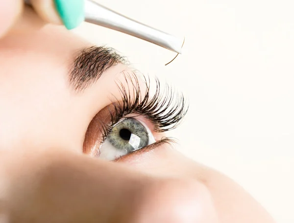 Beautiful young woman eyelash extension. Woman eye with long eyelashes. Beauty salon concept — Stock Photo, Image