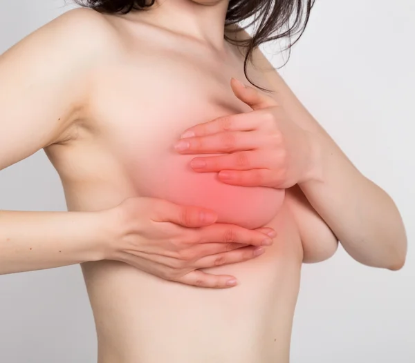 Meme kanseri kendini kontrol edin. Genç kadın göğüslerini topaklar veya meme kanseri belirtileri için incelenmesi. sağlıklı yaşam konsepti