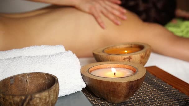 Mujer joven recibiendo un masaje de espalda en el salón de spa. cerca de las manos del masajista — Vídeos de Stock
