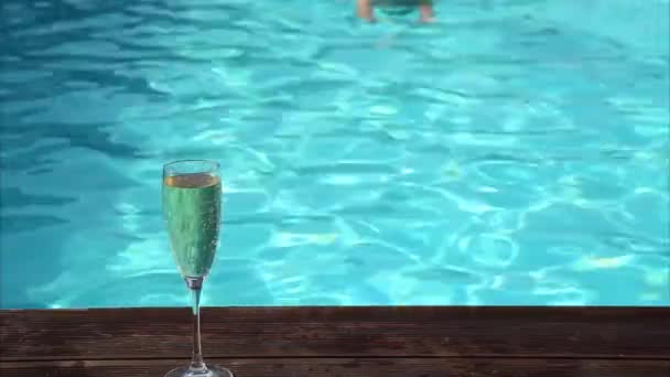 Giovane donna felice beve champagne in piscina — Video Stock