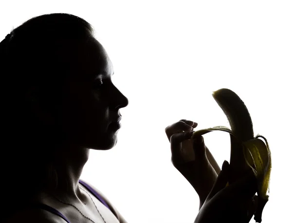年轻人惊讶中拿着一根香蕉的蕾丝内衣的女人，她要吃一根香蕉。她吸一根香蕉 — 图库照片