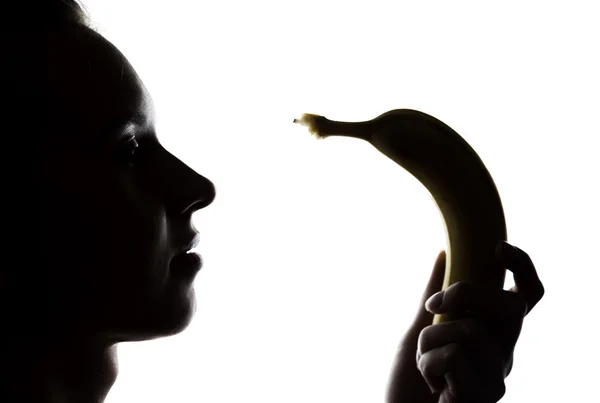 Joven mujer sorprendida en lencería de encaje sosteniendo un plátano, ella va a comer un plátano. chupa un plátano —  Fotos de Stock