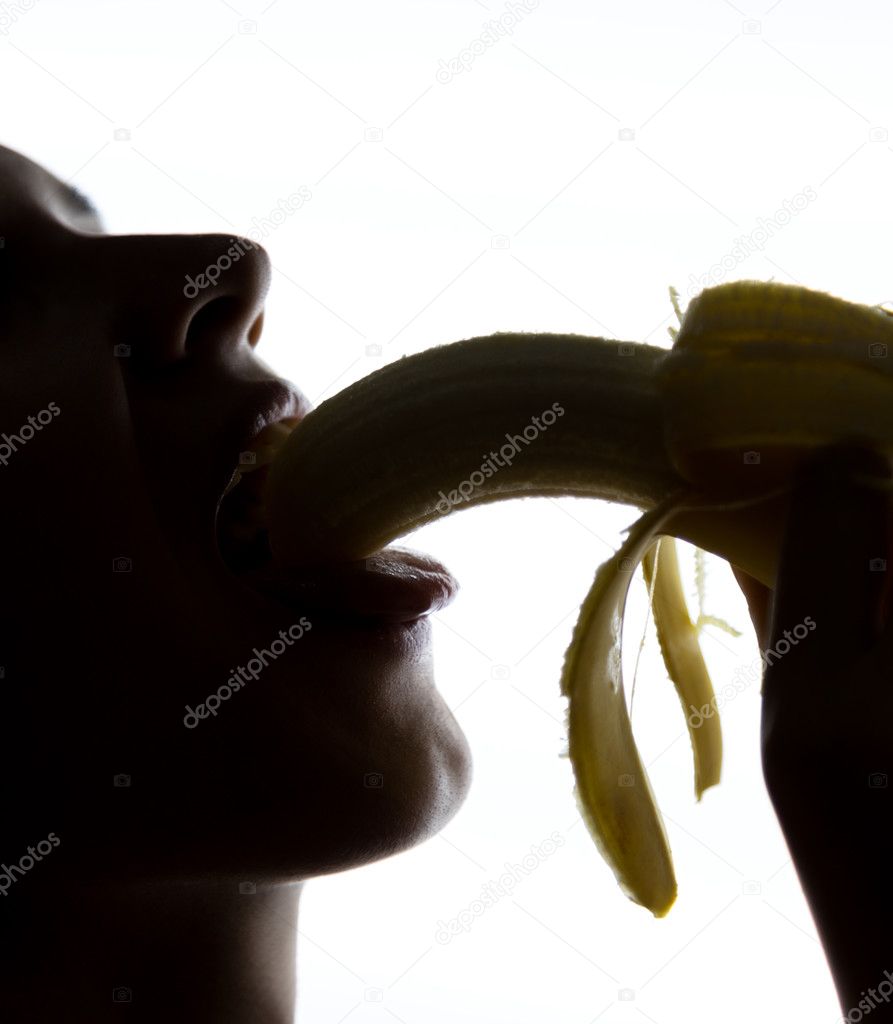 Close-up of Young amazed woman holding banana, she is going to eat a banana. she sucks a banana
