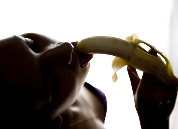 Young beautiful woman in lacy lingerie holding a banana, she is going to eat a banana. she sucks a banana — Stock Photo, Image