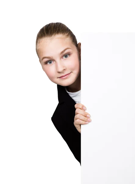 Little business woman standing behind and leaning on a white blank billboard or placard, expresses different — Stock Photo, Image