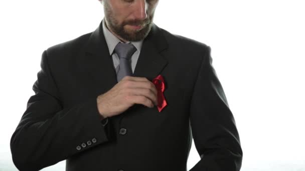 Aids Awareness. Close-up of man hands holding red AIDS awareness ribbon. — Stock Video