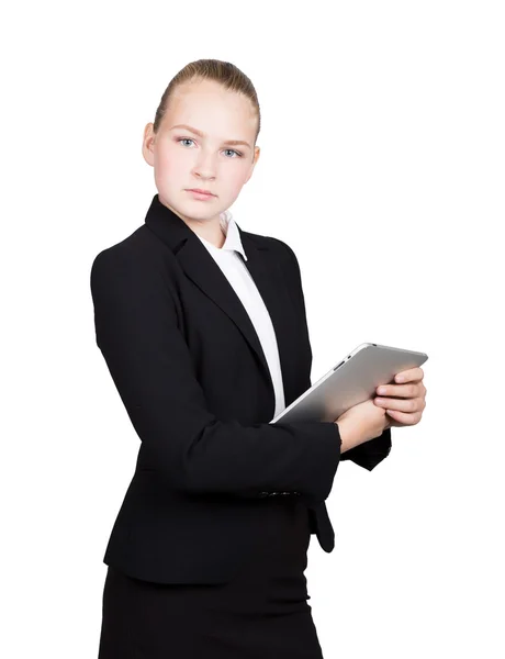 Mooie schoolmeisje in een Business Suit houdt een PC Tablet in zijn handen en op zoek naar de camera — Stockfoto